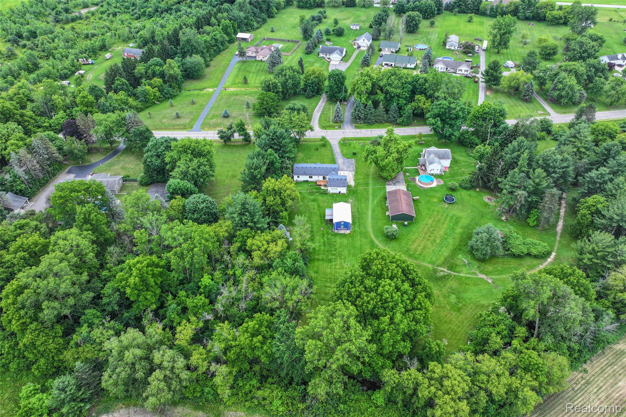 1336 West Hurd Road Clio, MI 48420 - Photo 9 of 43 Expansive property featuring a residence, detached outbuilding, and an above-ground pool