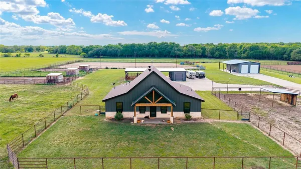 a view of a house with a yard balcony and outdoor seating