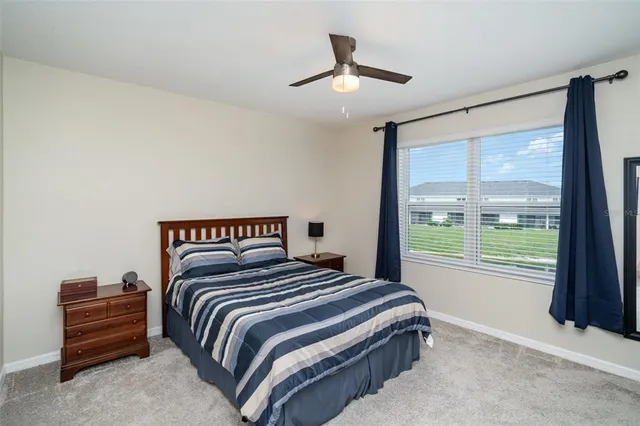 a bedroom with a large bed and a large window