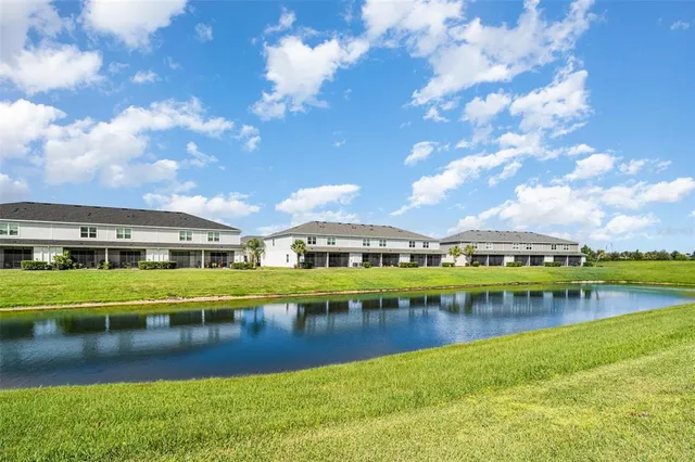 a view of a lake with houses in the back