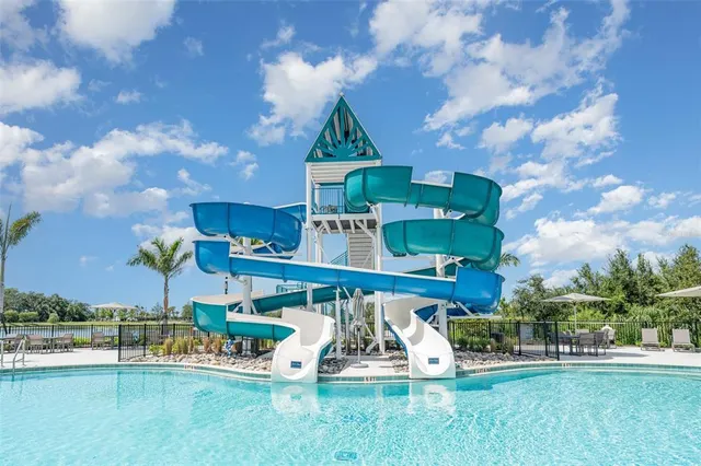 a view of a swimming pool with outdoor seating