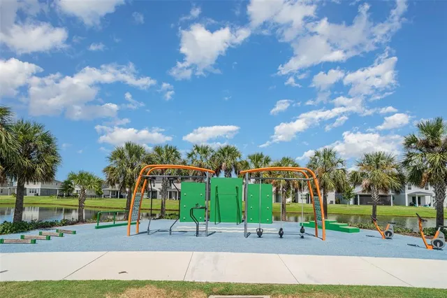 a living room with furniture kitchen view and a large window