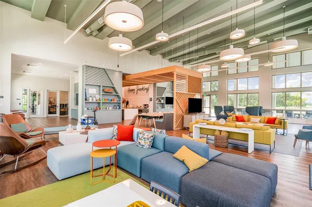 a living room filled with furniture and a large window