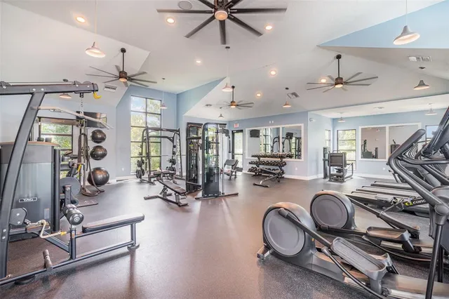 a living room with furniture a flat screen tv and a large window