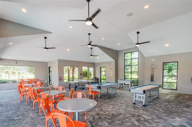 a view of a patio with swimming pool and table and chairs