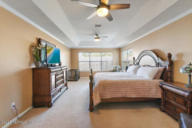 a bedroom with a bed wooden floor and window