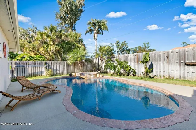 a view of a swimming pool with a lounge chair