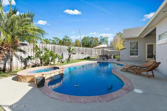 a view of a swimming pool with lounge chairs