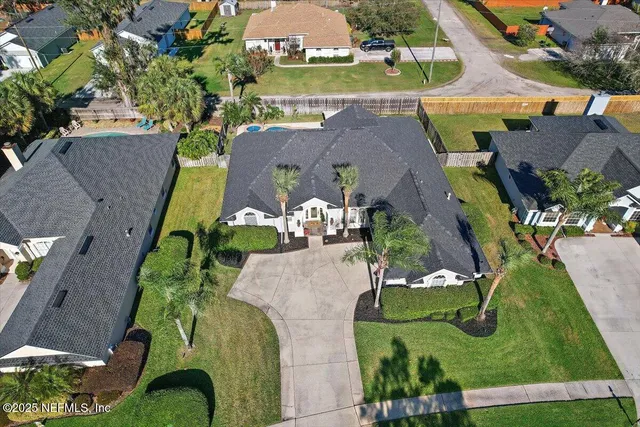 an aerial view of a house with yard swimming pool and outdoor seating