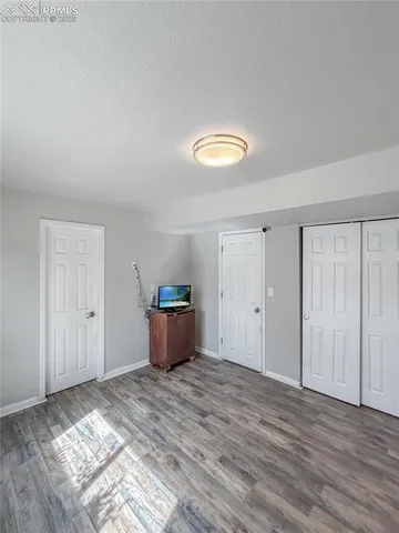 a view of a room with wooden floor and bathroom