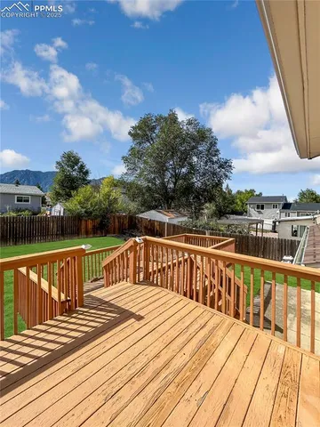 a view of balcony with wooden floor and fence