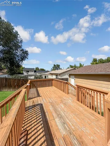 a view of balcony with wooden floor and fence