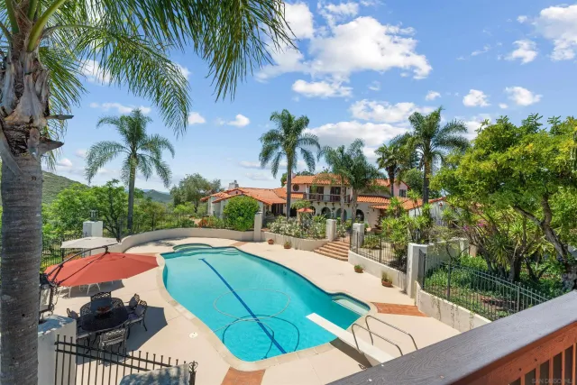 a view of a swimming pool with lounge chairs