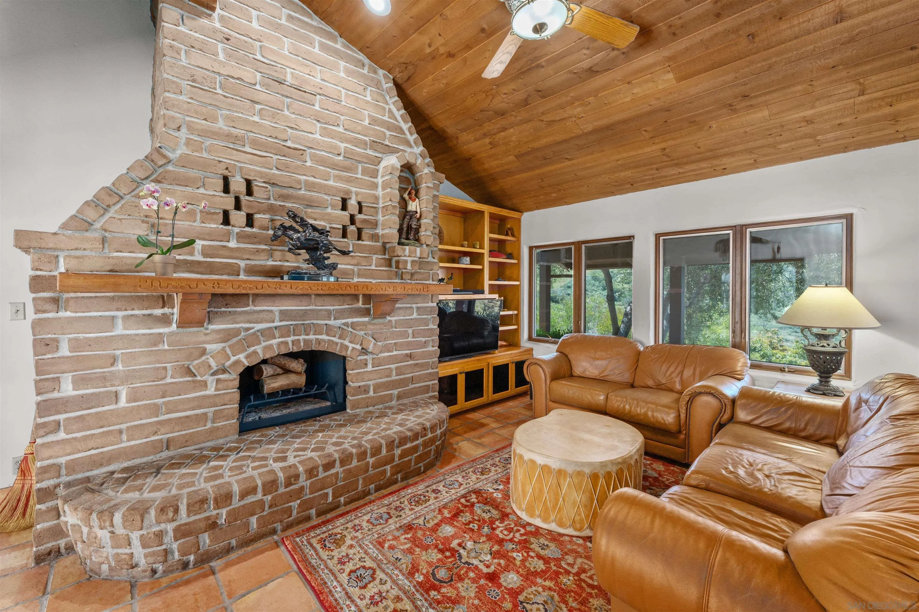 17156 Dos Hermanos Road Poway, CA 92064 - Photo 25 of 70 a living room with furniture and a fireplace