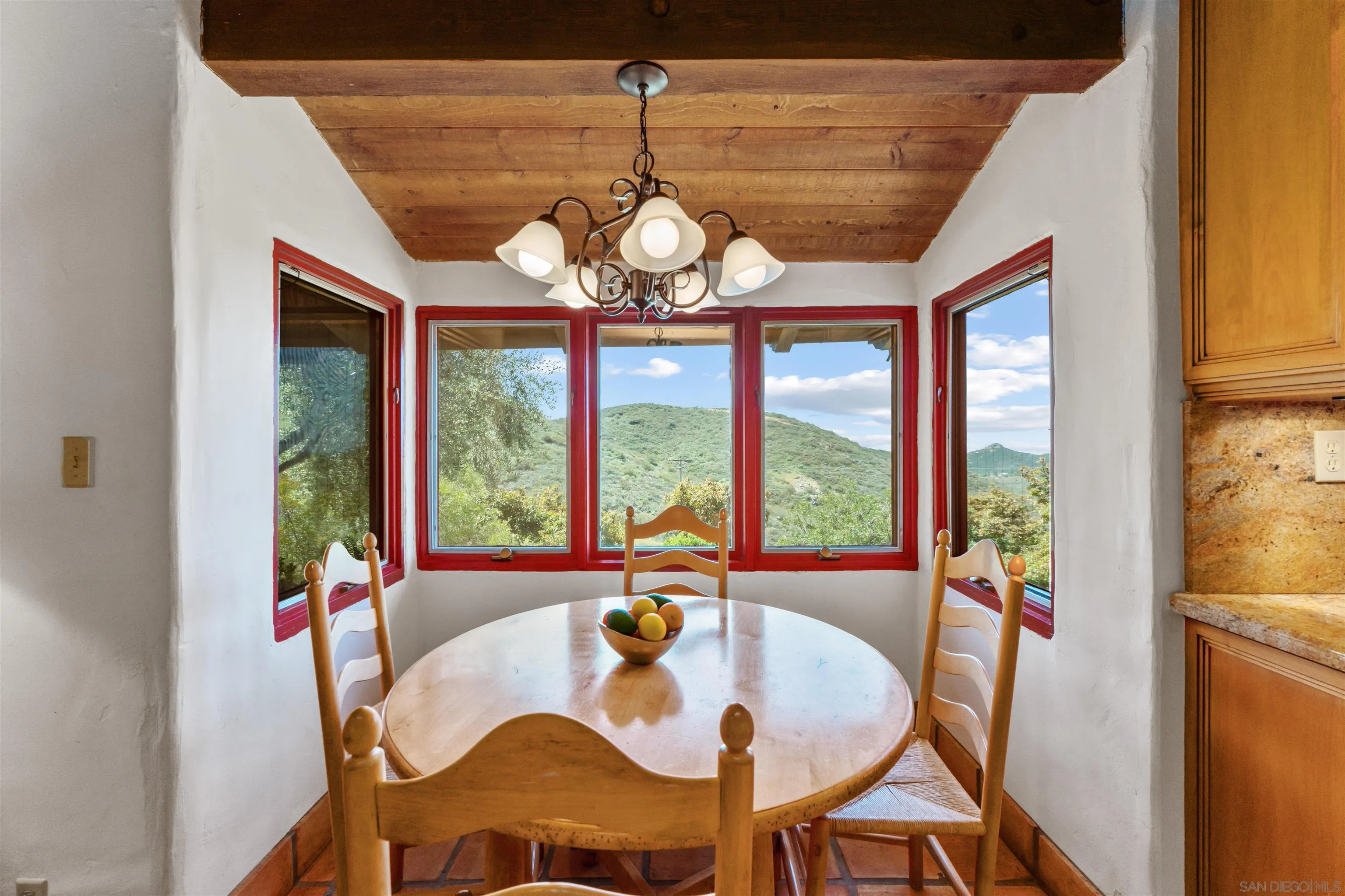 17156 Dos Hermanos Road Poway, CA 92064 - Photo 28 of 70 a dining room with wooden floor a chandelier