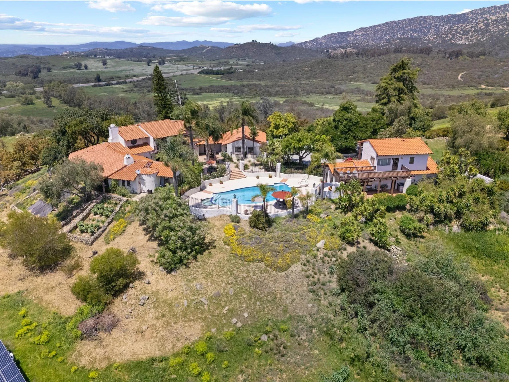 17156 Dos Hermanos Road Poway, CA 92064 - Photo 5 of 70 an aerial view of a house with a garden and lake view