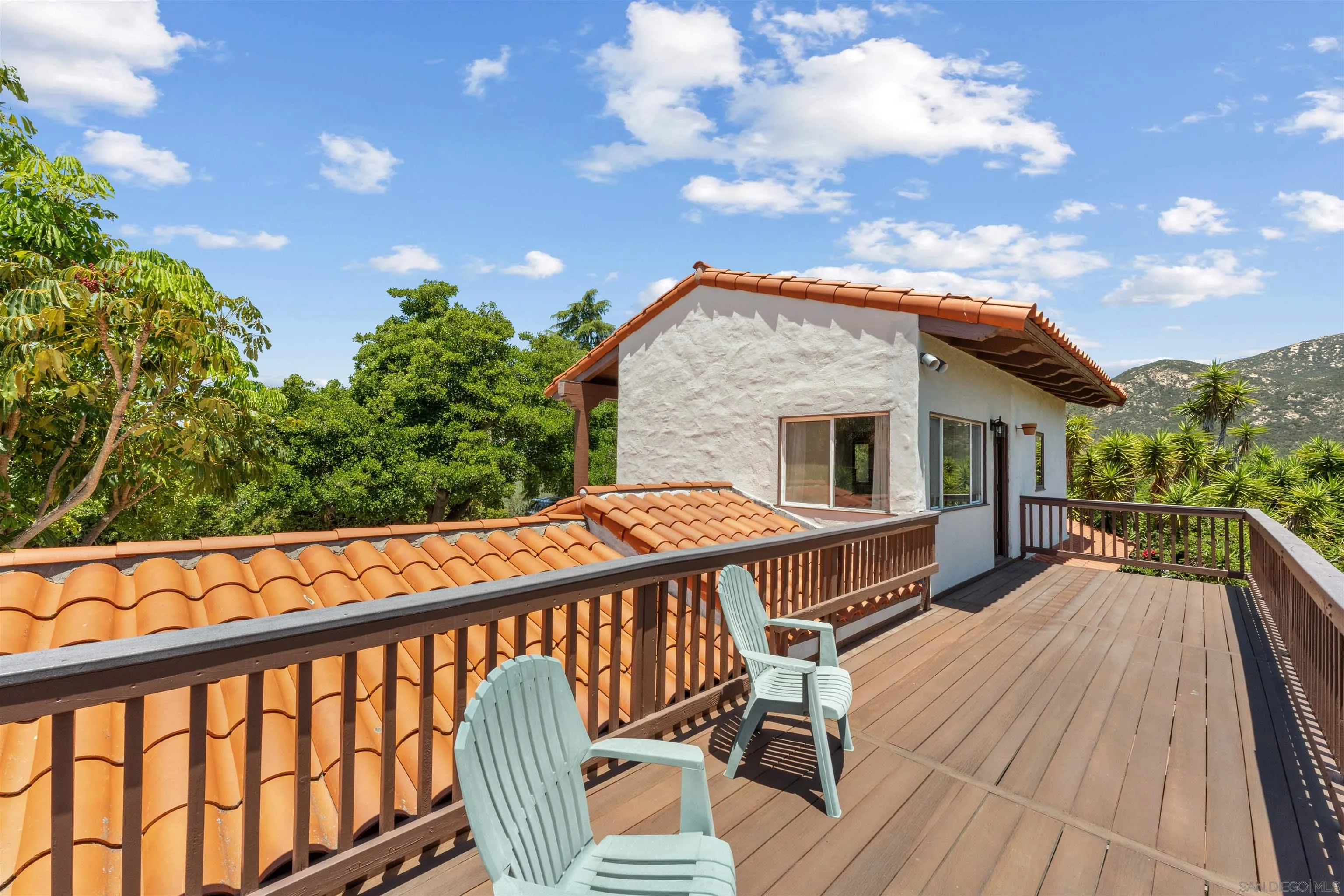 17156 Dos Hermanos Road Poway, CA 92064 - Photo 55 of 70 a balcony of a house with wooden floor outdoor seating and yard in the back