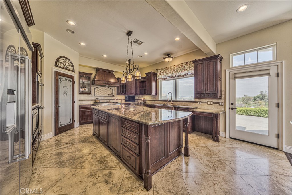 39700 Berenda Road Temecula, CA 92591 - Photo 17 of 71 a kitchen with stainless steel appliances granite countertop a stove a sink and a refrigerator