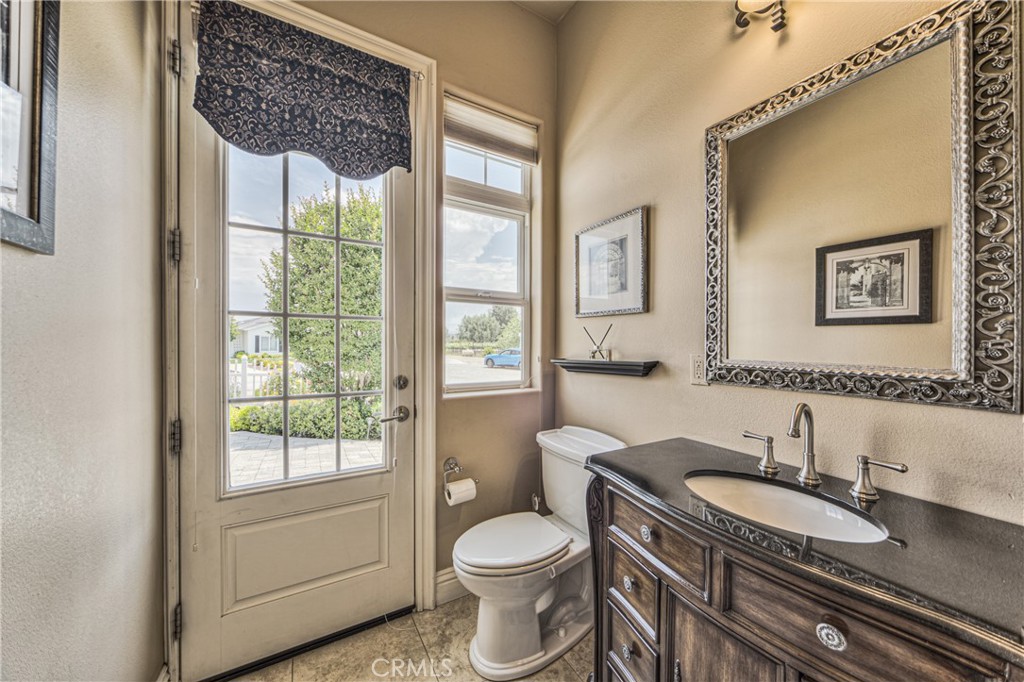 39700 Berenda Road Temecula, CA 92591 - Photo 18 of 71 a bathroom with a granite countertop sink toilet and a mirror