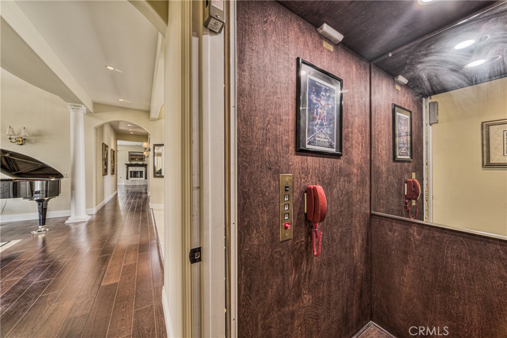 39700 Berenda Road Temecula, CA 92591 - Photo 19 of 71 a view of a hallway with wooden floor and stairs