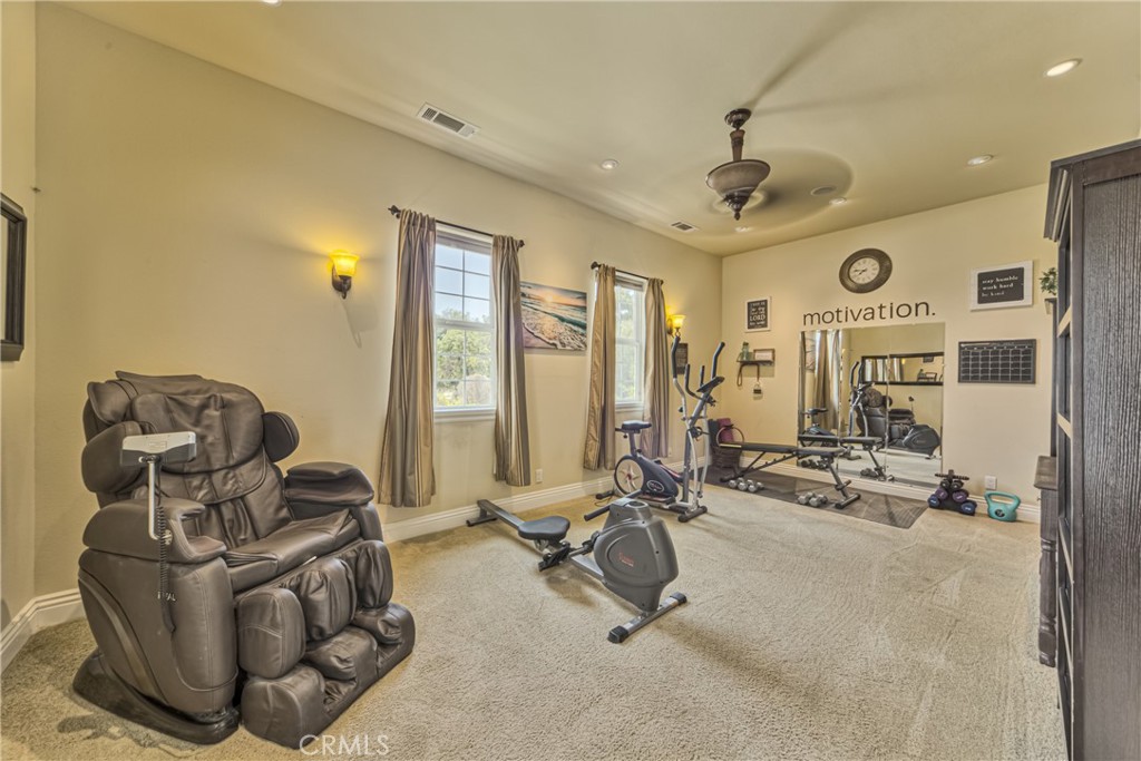 39700 Berenda Road Temecula, CA 92591 - Photo 25 of 71 a room with gym equipment and a large mirror