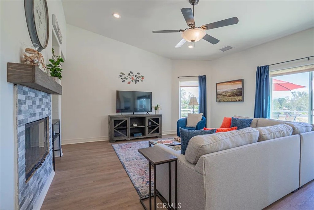 39700 Berenda Road Temecula, CA 92591 - Photo 57 of 71 a living room with furniture a flat screen tv and a fireplace