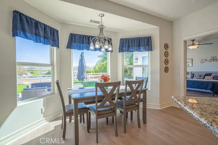 39700 Berenda Road Temecula, CA 92591 - Photo 58 of 71 a view of a dining room with furniture window and wooden floor