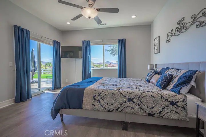 39700 Berenda Road Temecula, CA 92591 - Photo 59 of 71 a bedroom with a large bed and a chandelier