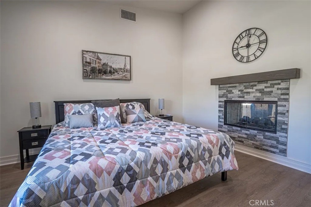 39700 Berenda Road Temecula, CA 92591 - Photo 64 of 71 a bedroom with a bed and a fireplace