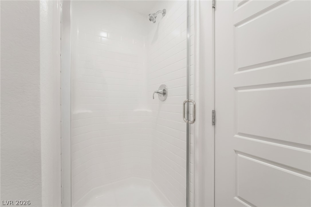 894 Cadence View Way Henderson, NV 89011 - Photo 11 of 23 A pristine shower enclosure with sparkling fixtures and contemporary design awaits your daily refresh.