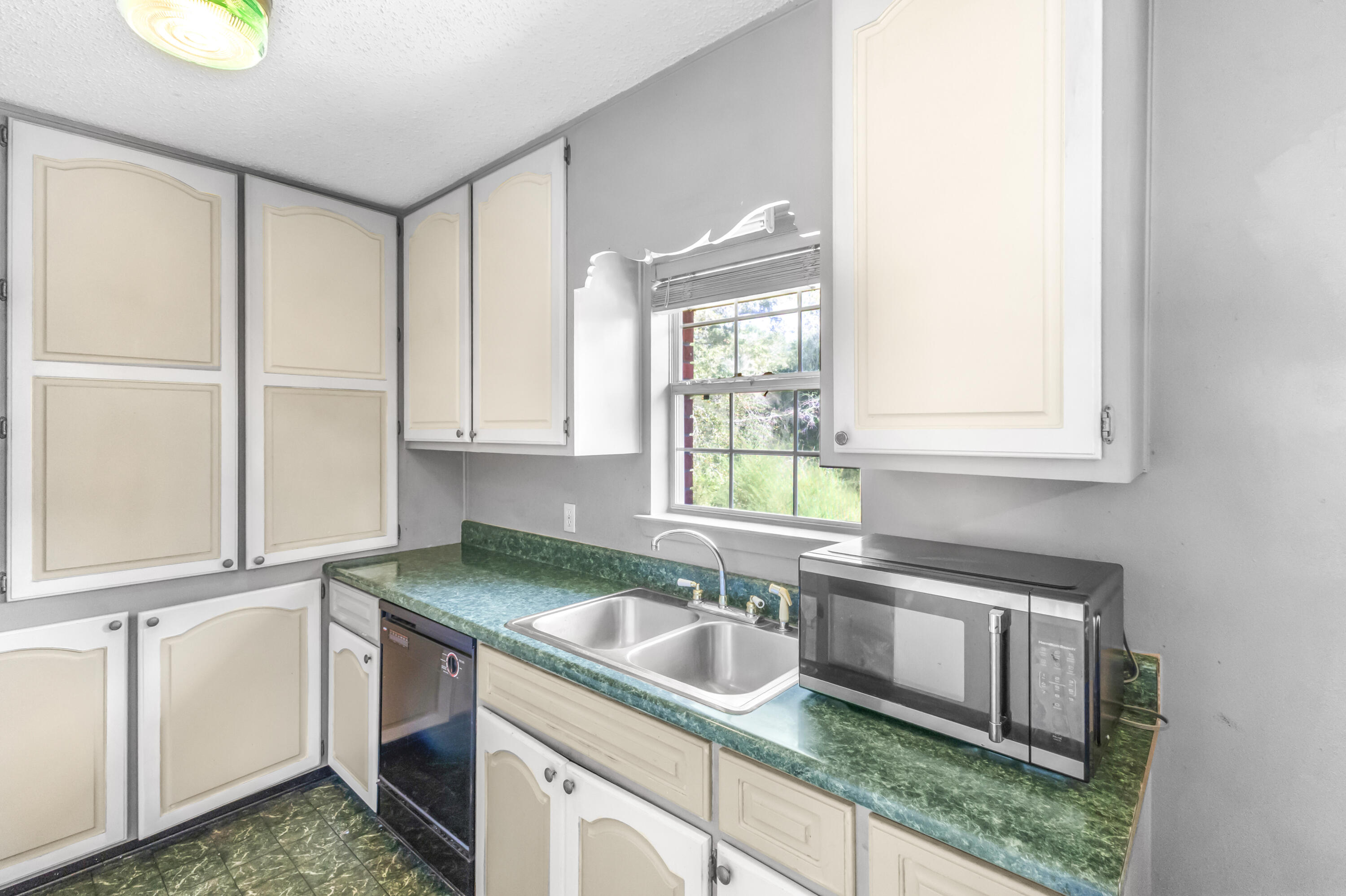 353 Florence Drive DeFuniak Springs, FL 32433 - Photo 6 of 16 a kitchen with granite countertop a sink a stove and cabinets