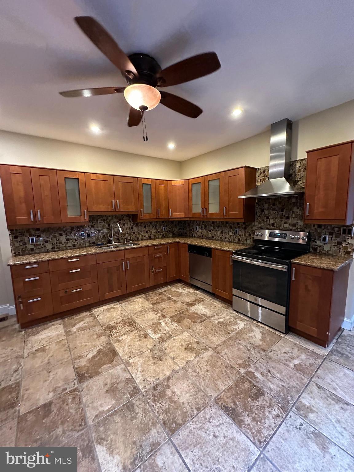 a large kitchen with stainless steel appliances and a large counter top