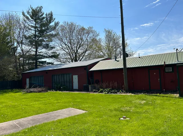 a front view of house with yard and green space