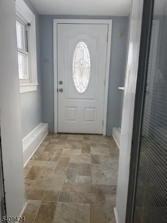 a view of a livingroom with wooden floor and window