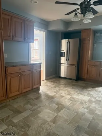 a kitchen with stainless steel appliances granite countertop a refrigerator a stove and a sink