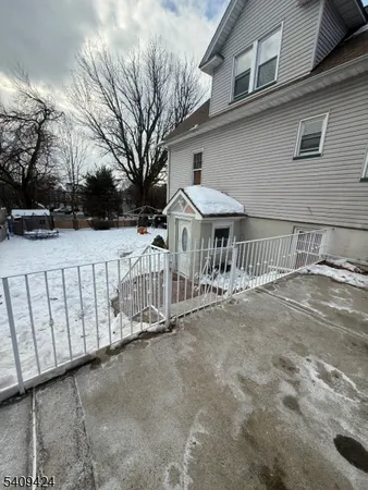 a view of a house with a wooden fence
