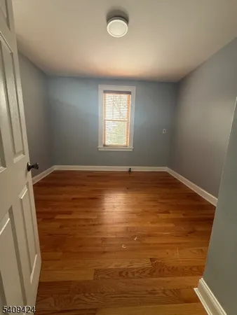 a view of room with window and hardwood floor