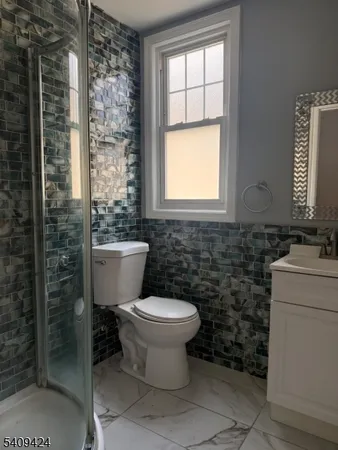 a bathroom with a toilet sink and a shower