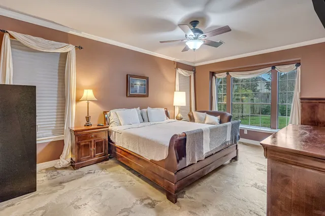 a bed room with a bed and a large window