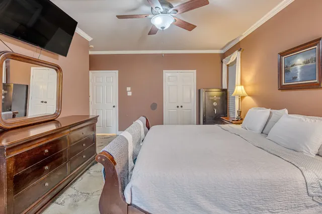 a spacious bedroom with a bed and a chandelier