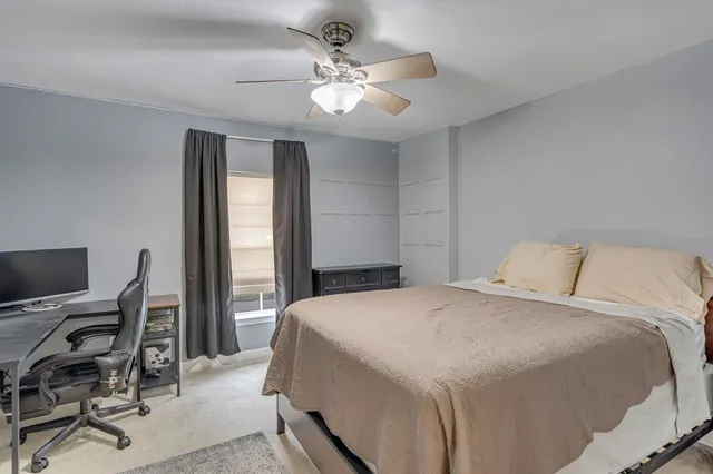 a bedroom with a large bed and a window