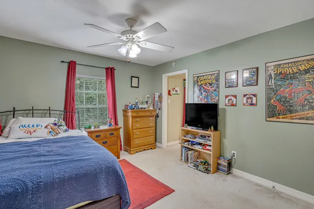a bedroom with bed and a flat screen tv