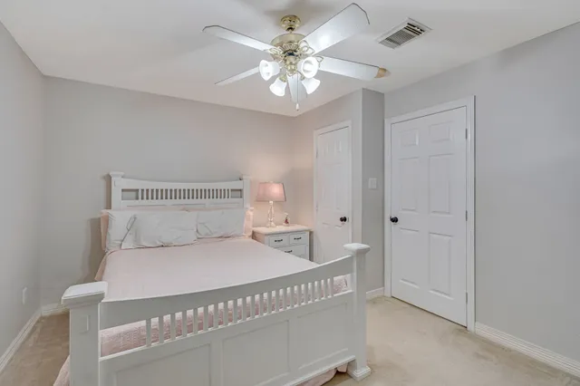 a bedroom with a large bed and a chandelier