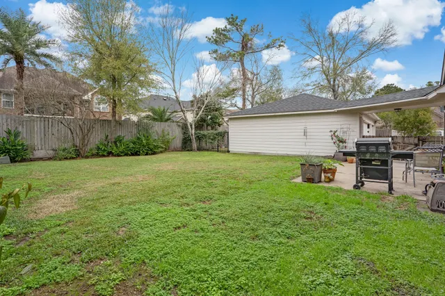 a view of a house with a yard and sitting area