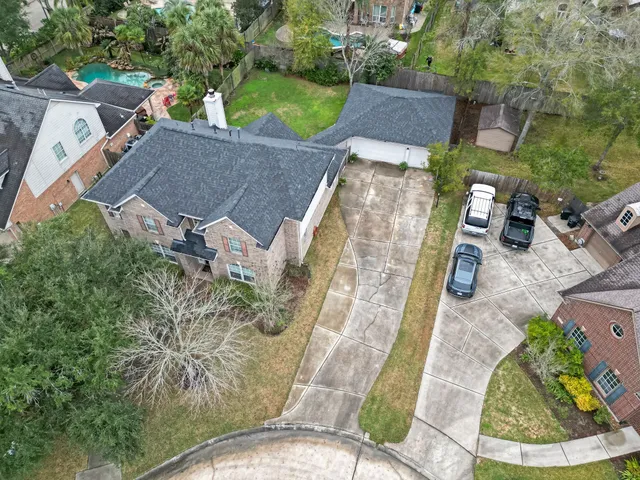 an aerial view of a house with garden space and street view