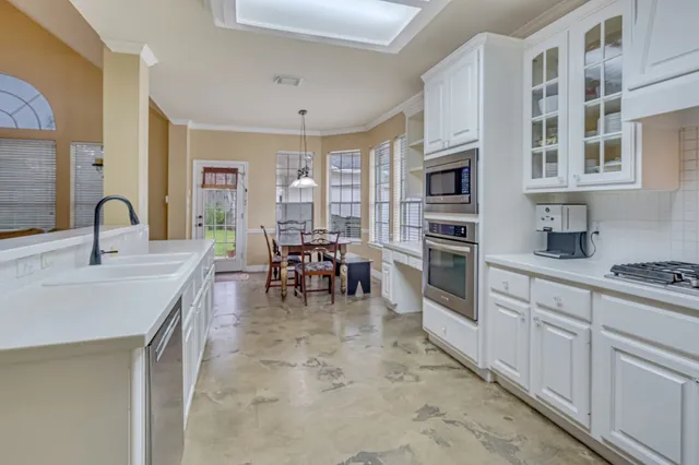 a kitchen with stainless steel appliances a sink and cabinets