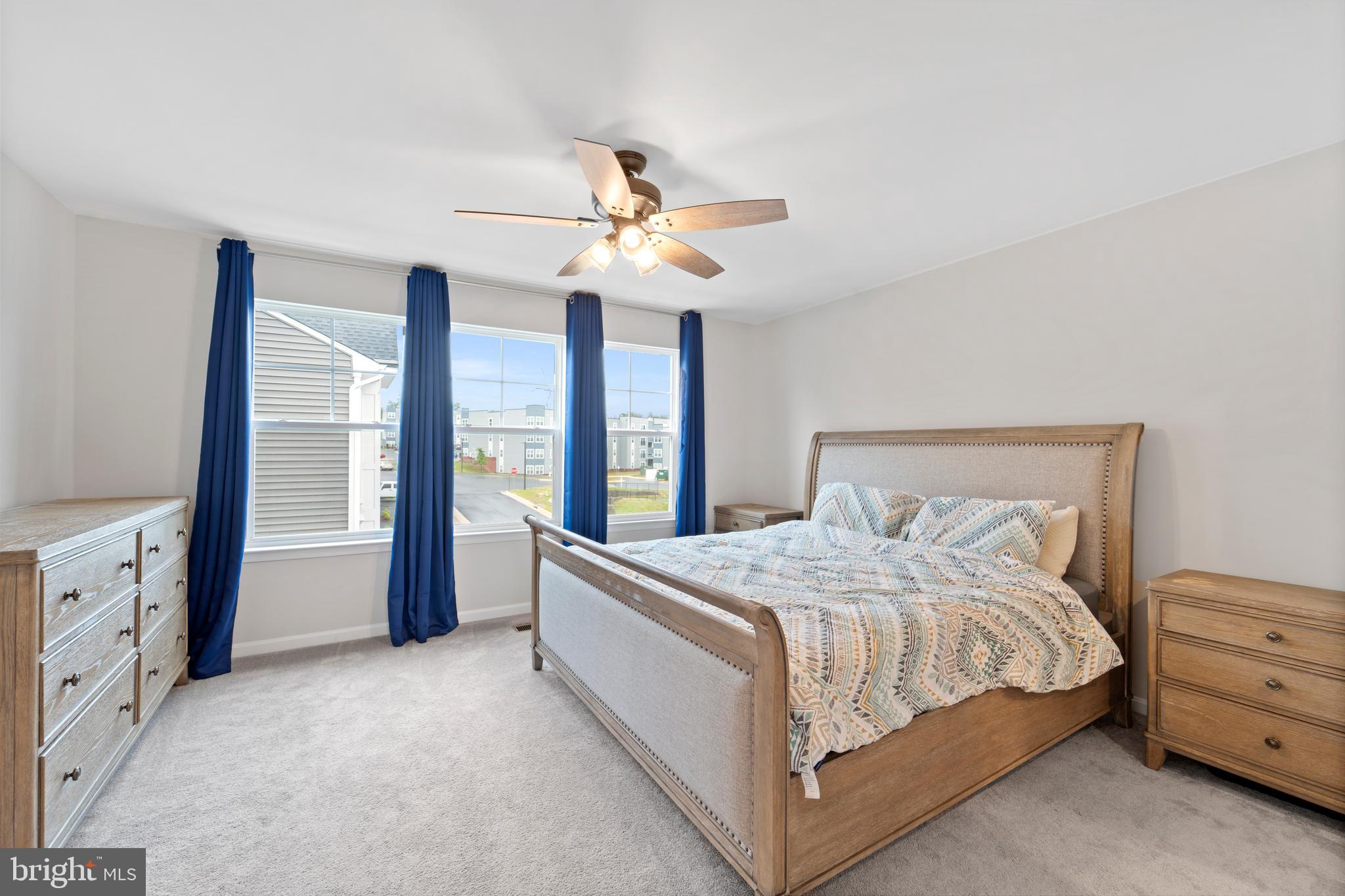 18216 Summit Pointe Drive Triangle, VA 22172 - Photo 12 of 25 a bedroom with a large bed and a chandelier fan
