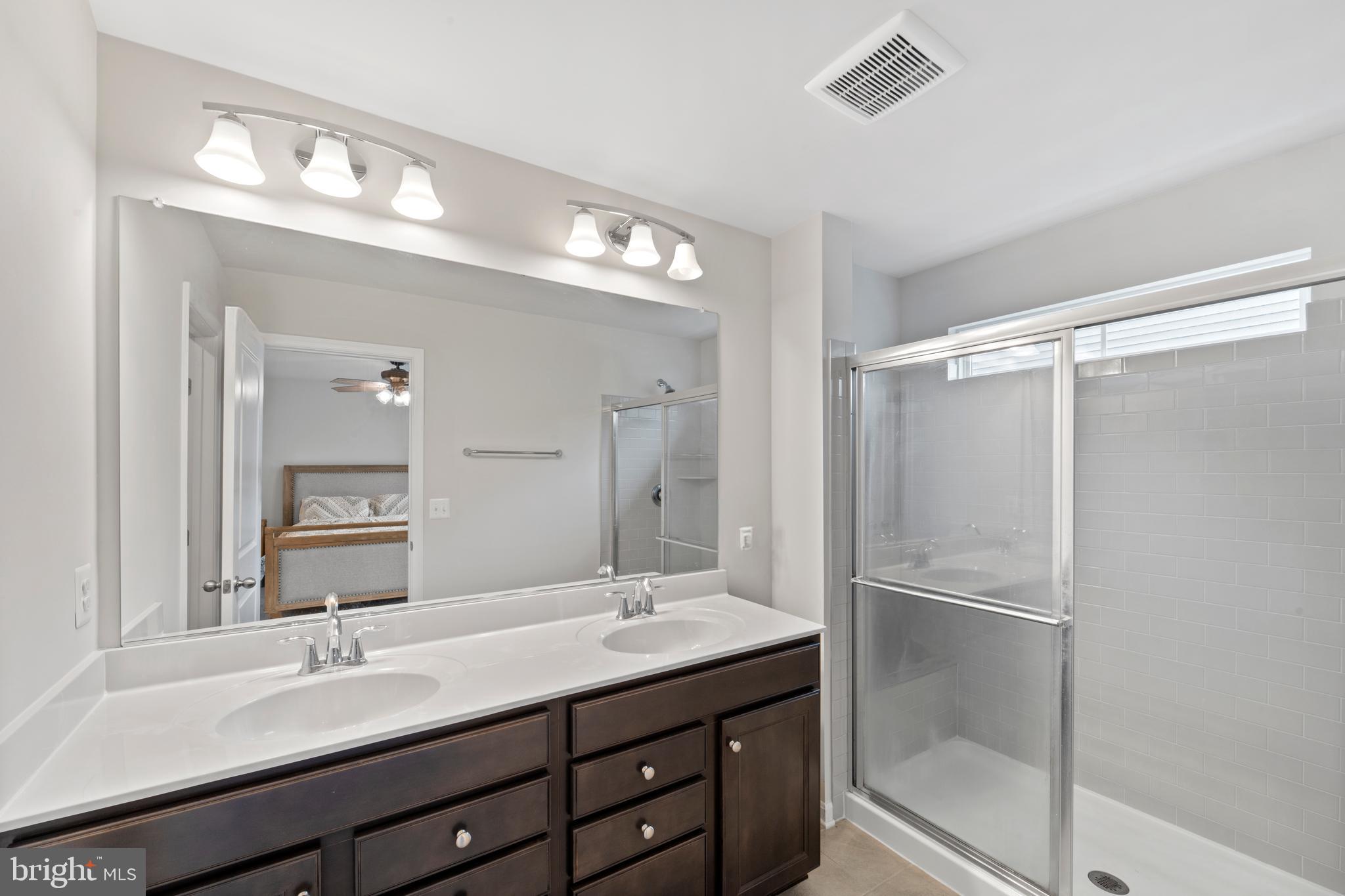 18216 Summit Pointe Drive Triangle, VA 22172 - Photo 14 of 25 a bathroom with a double vanity sink mirror and shower