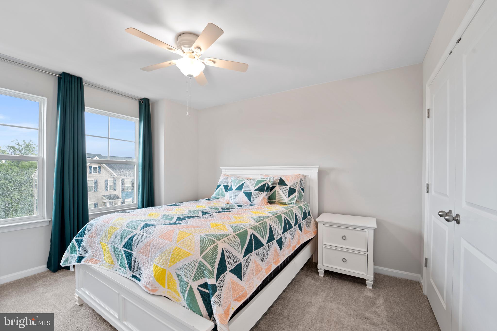 18216 Summit Pointe Drive Triangle, VA 22172 - Photo 17 of 25 a bedroom with a bed and a large window