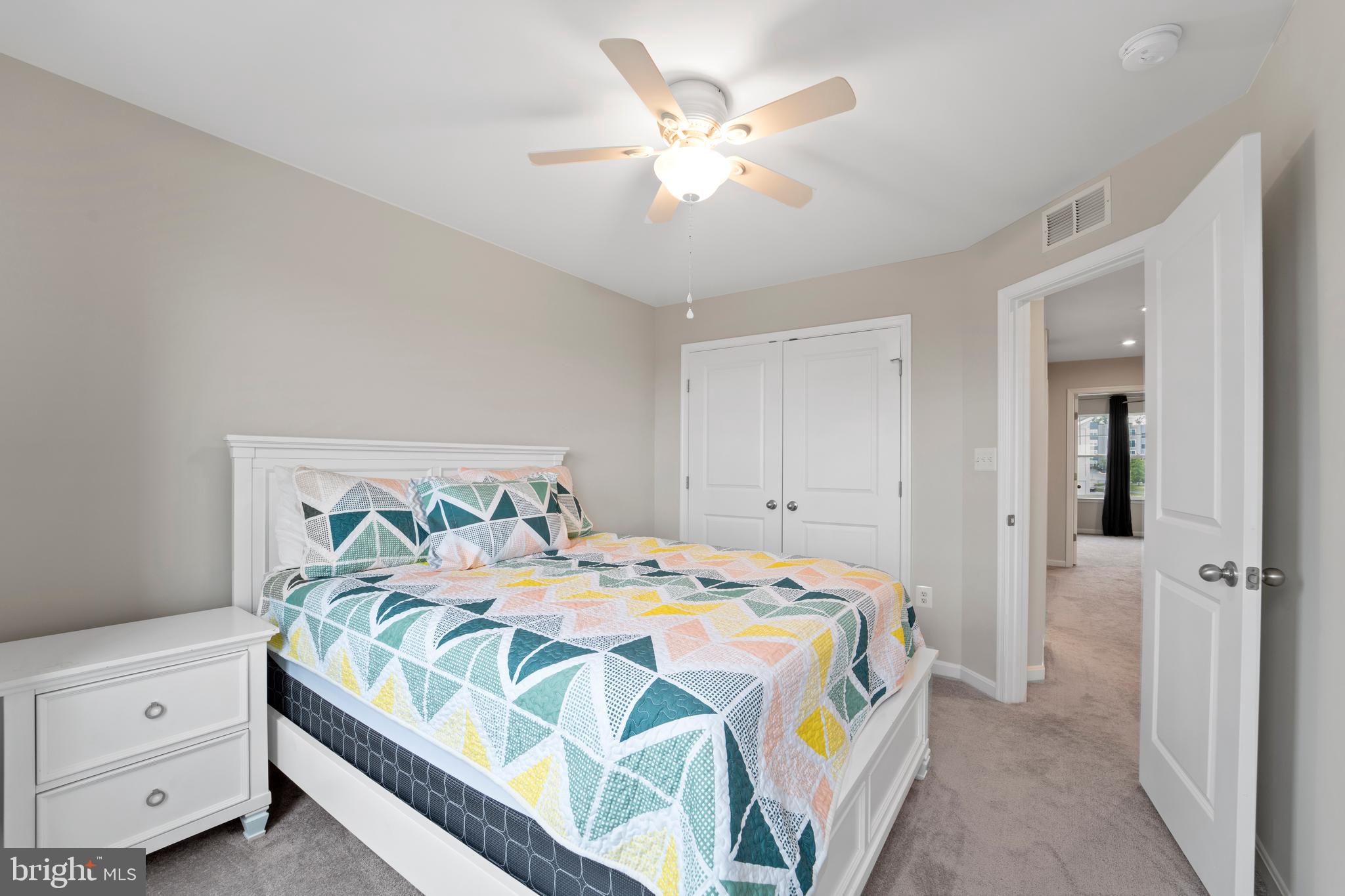 18216 Summit Pointe Drive Triangle, VA 22172 - Photo 18 of 25 a bedroom with a bed and a chandelier